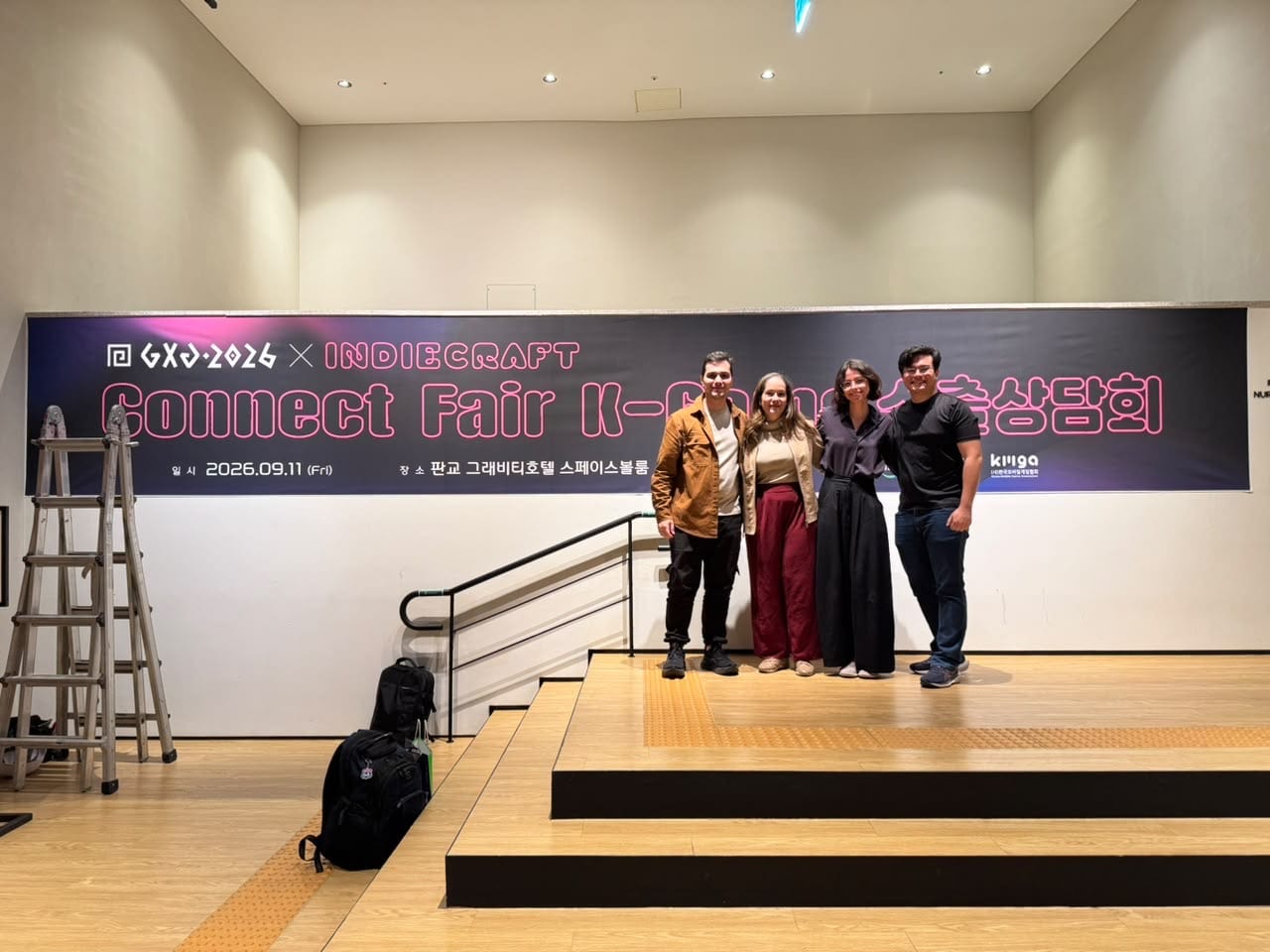 Four people standing on a stage in front of the GXG 2026 × INDIECRAFT Connect Fair banner